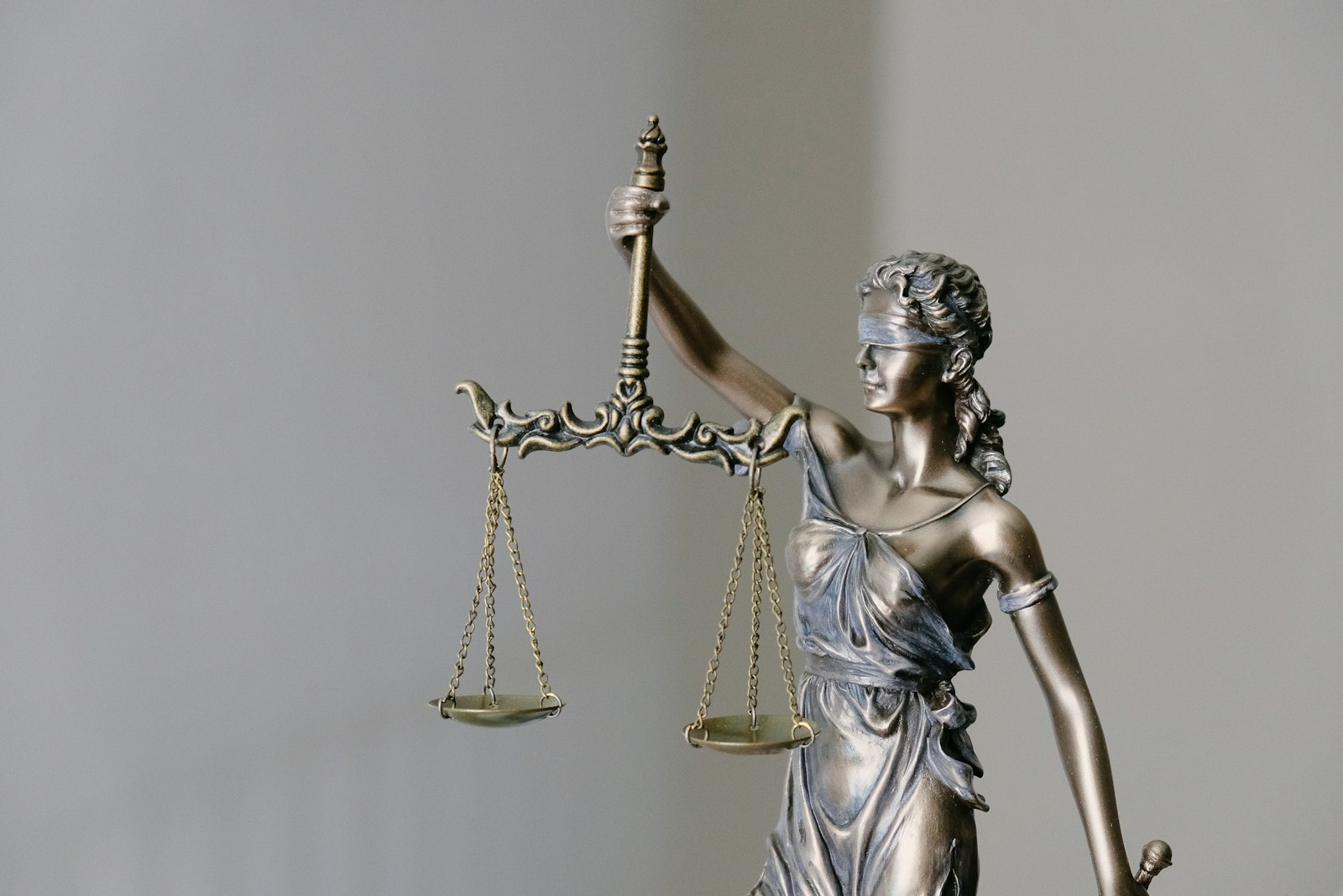 Lady Justice statue with scales representing law firms and legal services