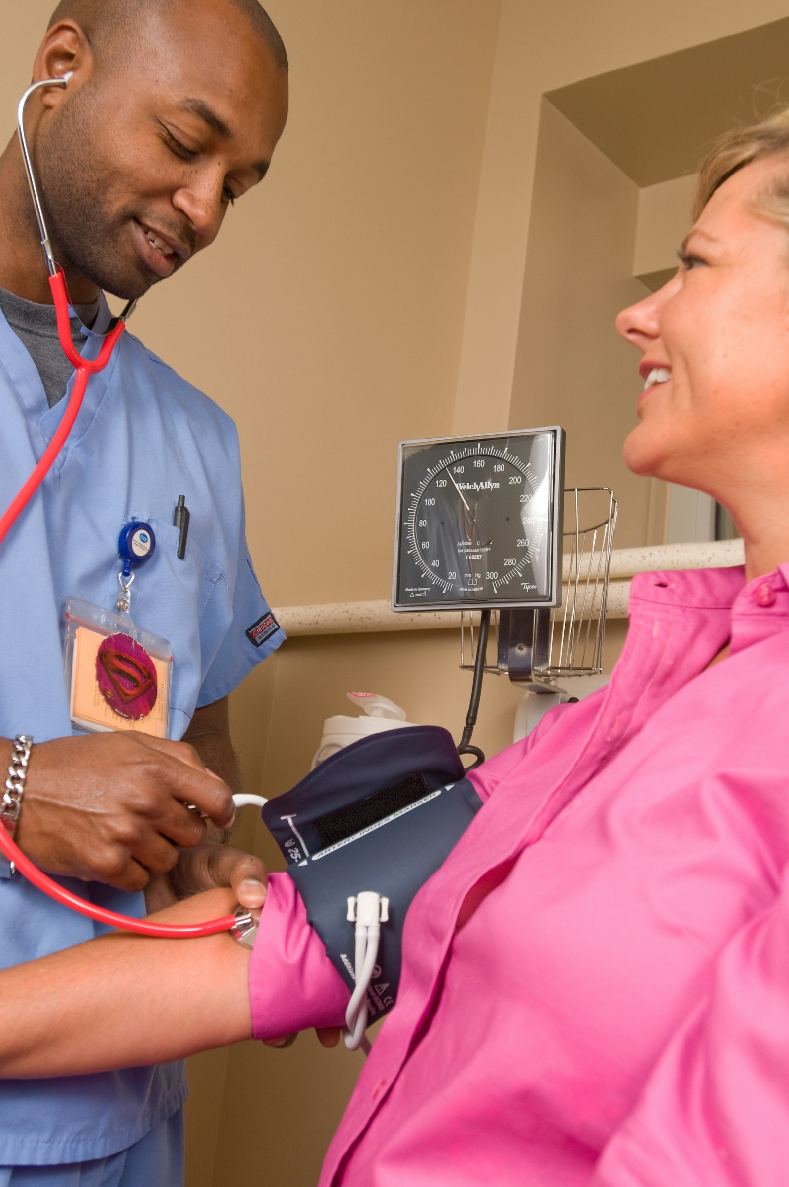 Healthcare professional taking a patient blood pressure reading in a medical practice
